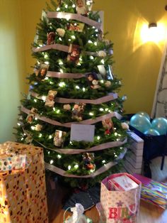 a decorated christmas tree with presents under it