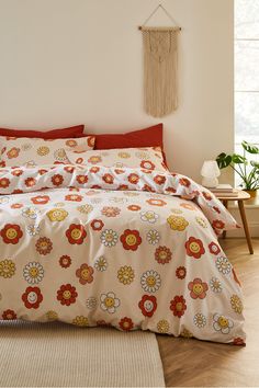 a bed with red and yellow flowers on it