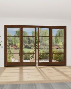 an empty room with sliding glass doors leading to a garden