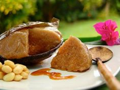 a white plate topped with food next to a pink flower