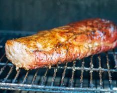 a piece of meat is cooking on the grill