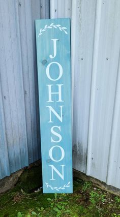 a wooden sign with the word johnson painted on it