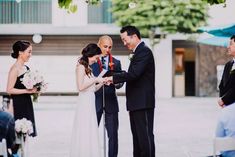 a man and woman standing next to each other in front of an audience at a wedding