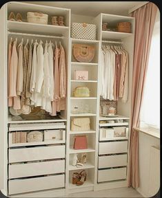 an organized closet with clothes, shoes and handbags on the shelves in front of it