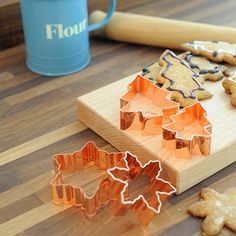 cookie cutters and cookies on a cutting board