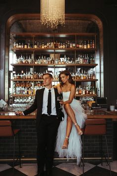 a man and woman sitting at a bar