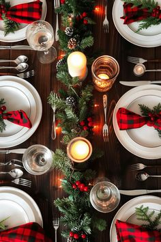 the table is set for christmas dinner with red and green napkins, silverware