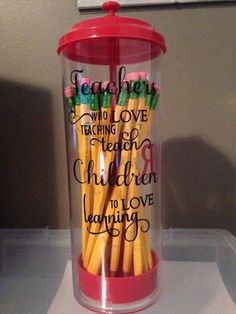 there is a cup that has some pencils in it