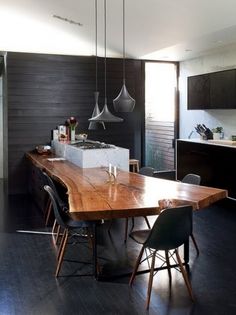 a large wooden table sitting in the middle of a kitchen