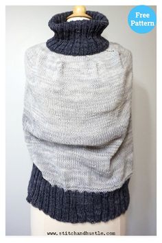 a white and blue sweater with a wooden hanger on the top that is attached to a mannequin