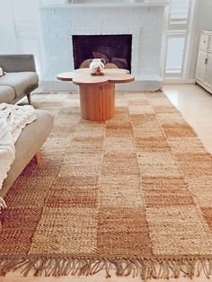 a living room with a couch, coffee table and fireplace