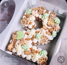 a box filled with lots of decorated cookies