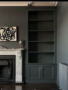 a living room filled with furniture and a fire place in front of a book case