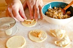 the person is making homemade pastries on the table with bowls and measuring spoons