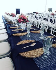 a table set up with place settings and flowers