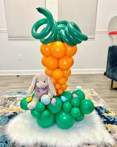 an elephant sitting on top of a bunch of balloons in the middle of a room