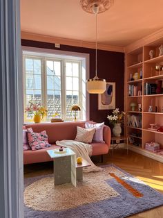 a living room filled with furniture and lots of bookshelves on top of it