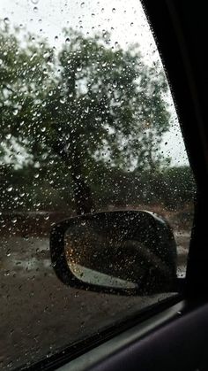 rain is falling on the windshield of a car