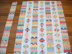 the quilts are laid out on the floor to be made into a table runner