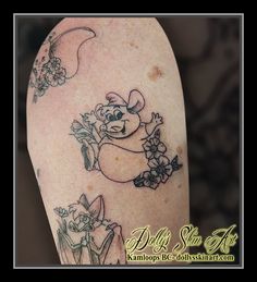 a tattoo on the arm of a woman with flowers in her hair and an image of a bear