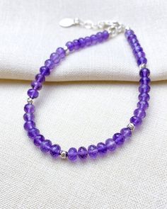 Treat her royally, with a gemstone bracelet the color of royalty. This sublime beaded bracelet features a strand of micro-faceted amethyst stones in the most rich shade of purple. Small sterling silver beads interspersed along the strand add extra brilliance to this refined design. A secure lobster clasp and extender chain allow a comfortable fit for most wrists, so you can be confident when gifting that it will fit. Amethyst is the birthstone for February Amethyst is also traditionally given for the sixth wedding anniversary Amethyst is a purple shade of quartz Bracelet length: 7.25 inches plus 1-inch extender Materials: 3.5-4 mm amethyst beads, .925 sterling silver components, multi-strand stainless steel beading wire Free USA shipping and returns. Elegant Amethyst Gemstone Crystal Bracelet, Sterling Silver Rondelle Gemstone Beaded Bracelets, Adjustable Purple Beaded Bracelet With Faceted Beads, Purple Rondelle Beaded Bracelets As Gift, Adjustable Purple Beaded Bracelets With Faceted Beads, Spiritual Rondelle Faceted Beaded Bracelets, Elegant Sterling Silver Crystal Bracelet With Gemstone Beads, Elegant Lavender Beaded Bracelets With Faceted Beads, Elegant Lavender Bracelets With Faceted Beads