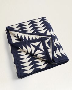 a blue and white blanket folded on top of each other