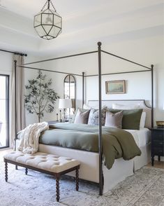 a bedroom with a canopy bed and pillows