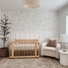 a baby's room with a crib and chair