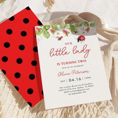 two red and black polka dots are next to the baby's first birthday card