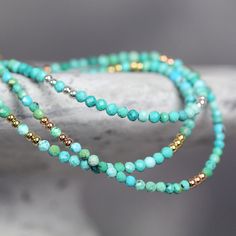 This handmade, genuine Turquoise Bracelet for women is dainty yet striking, bringing a colourful, boho touch to any outfit. Stylish and minimal worn alone, but great to mix, match & stack. A very dainty, skinny bracelet with a delicate, feminine, minimal look - made with 2.25mm tiny turquoise beads. Featuring genuine, natural, un-dyed Turquoise in a variety of green, turquoise and teal shades - all the beautiful shades of the tropical seas! Excellent cut with many facets, showing off the gor Turquoise Wrap Bracelet With Round Beads As Gift, Bohemian Turquoise Friendship Bracelets With Spacer Beads, Turquoise Bracelets With Tiny Beads As Gift, Turquoise Bracelets With Tiny Beads For Gifts, Turquoise Beaded Bracelets With Faceted Beads For Festival, Festival Turquoise Beaded Bracelets With Faceted Beads, Turquoise Wrap Bracelet With Colorful Beads, Turquoise Wrap Bracelet With Faceted Beads As Gift, Turquoise Gemstone Beaded Bracelets For Festivals