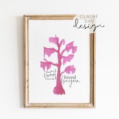 a pink tree is hanging on the wall