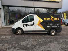 a white van parked in front of a building