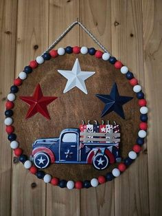 a wooden sign with an old truck and stars on it hanging from a wood wall