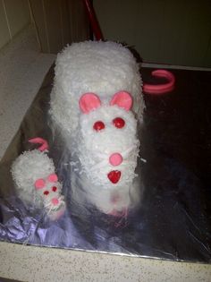 a cake with white frosting and pink decorations