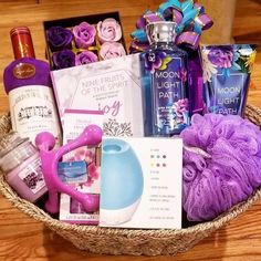 a basket filled with lots of items on top of a wooden table next to a bottle