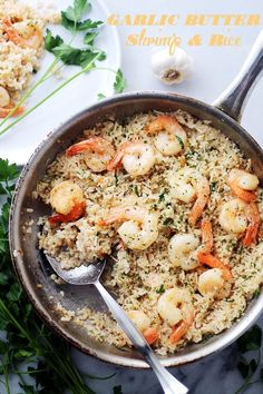 a pan filled with shrimp and rice on top of a table