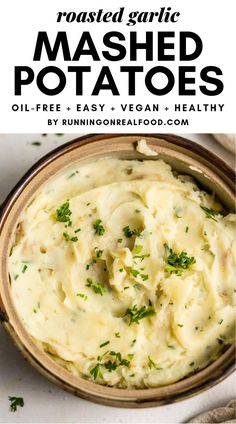 mashed potatoes in a bowl with parsley on top and text overlay that reads roasted garlic mashed potatoes