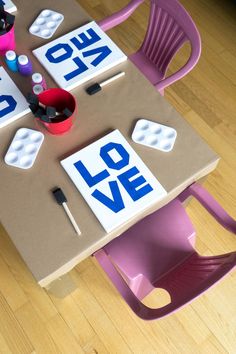 the table is made out of cardboard and has letters that spell out love on it