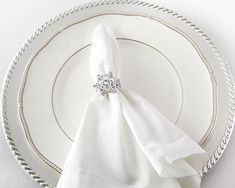 a white plate topped with a napkin next to a fork and knife