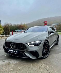 the mercedes amg coupe is parked in a parking lot with other cars behind it