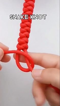 someone is holding the end of a red rope