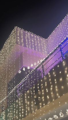 the building is decorated with lights and snowflakes