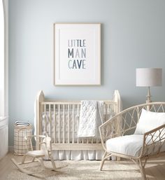 a baby's room with a white crib, blue walls and pictures on the wall