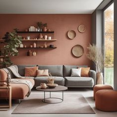 a living room with an orange wall and grey couches, coffee table and shelves on the wall