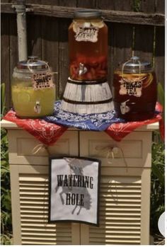 there are three jars on top of the stove with different drinks in them and a sign that says, walking hole