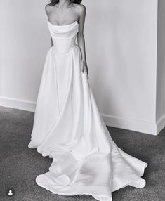 a black and white photo of a woman in a wedding dress