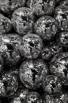 black and white photograph of disco balls with silver sequins in the middle,