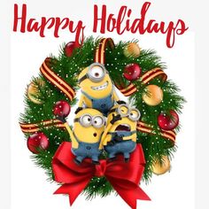 two minion minions sitting on top of each other in front of a christmas wreath