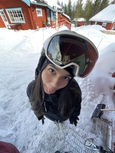 a woman wearing a helmet and goggles in the snow