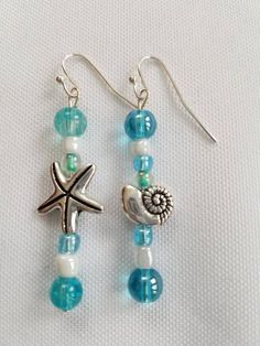 Mismatched Starfish and Shell Earrings.  Shiny and Blue looks so beachy.   These earrings would look great with a matching beaded beachy bracelet.  The piece of jewelry for those who love the beach!  FREE domestic shipping! Starfish-shaped Beaded Beach Jewelry, Starfish Charm Strand Jewelry For Beach Season, Beach Season Starfish Charm Strand Jewelry, Bohemian Summer Jewelry In Ocean Color, Summer Bohemian Blue Jewelry, Summer Bohemian Style Blue Jewelry, Summer Bohemian Ocean Color Jewelry, Beachy Starfish Charm Jewelry For Vacation, Bohemian Starfish Jewelry For Beach Season